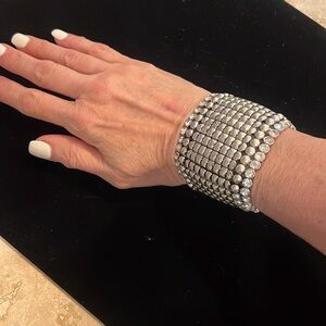 Big silver and rhinestone studded bracelet stretch to fit any wrist.